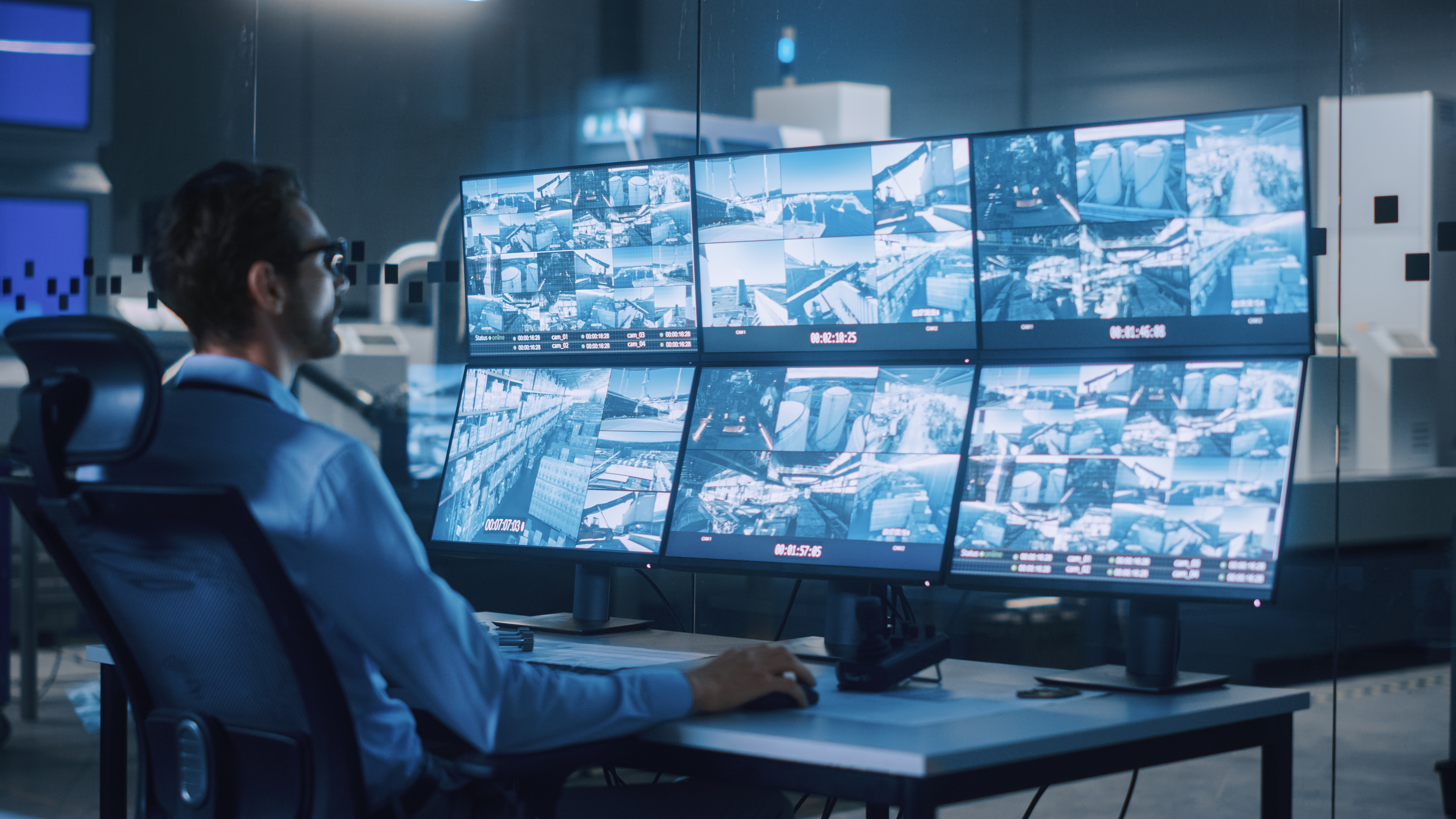 man in front of monitors